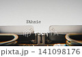 Old mechanical typewriter typing Ethnic Cleansing in a close up view, with metal letters striking the white paper. 141098176