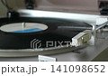 Listening to analog records on a record player 141098652