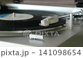Listening to analog records on a record player 141098654