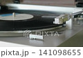 Playing analog records on a record player 141098655