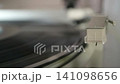 Playing analog records on a record player 141098656