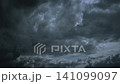 Dark ominous storm clouds with a break of light in the center Dark ominous storm clouds with a break of light in the center 141099097