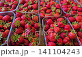 Fresh ripe strawberries in plastic containers at local farmers market with seasonal summer berries close up 141104243