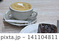 Brownie and coffee Cozy Caf Moment Latte Art and Chocolate Brownie on a Wooden Table 141104811
