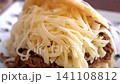 Arepa, a traditional Venezuelan dish, is a sandwich filled with shredded beef and plenty of cheese. 141108812