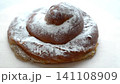 A traditional Spanish pastry from Mallorca, "Ensaimada," slowly rotates against a white background. 141108909