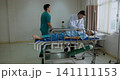 Doctor checking symptoms in hospital room, emergency patient receiving treatment, medical team work 141111153