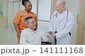 Doctor holding the hand of a patient in hospital, giving encouragement, trusting in medical care 141111168