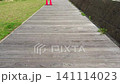 Walking along a wooden walkway 141114023