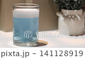 Cleaning a dental retainer in a glass of water with a tablet 141128919
