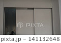 Stuck elevator shaft gap with half-open doors. Handheld. 141132648