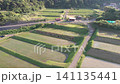 A drone aerial view of the "Arai Rice Terraces" in Ine, Kyoto, slowly moving forward towards the lush, terraced fields. 141135441