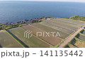 A drone slowly moves forward, capturing the beautiful terraced rice fields of Arai in Ine, Kyoto, with the Sea of Japan as a backdrop. 141135442