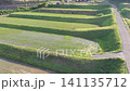 A drone-like aerial view of the Arai rice terraces in Ine, Kyoto, as it slowly moves straight forward from a low position to a higher one. 141135712