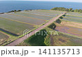 A drone slowly advances towards the "Arai Rice Terraces" in Ine, Tokyo, where geometrically shaped terraced fields spread out against the backdrop of the Sea of Japan. 141135713