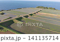A drone slowly descends towards the rice terraces of Arai in Ine, Kyoto, with a light truck driving by. 141135714