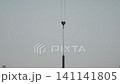 Housing development: installing concrete wall segments with a crane 141141805