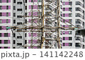 Urban renewal showcasing colorful lifting equipment. Energetic metropolitan development highlighting vivid structural cranes and continual city enhancement 141142248