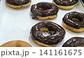 Classic ring donuts coated with a thick and glossy chocolate glaze. 141161675