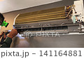 Air Conditioner Cleaning and Maintenance Service Technician Repairing Indoor AC Unit 141164881