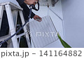 Air Conditioner Cleaning and Maintenance Service Technician Repairing Indoor AC Unit 141164882