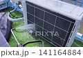 Air Conditioner Cleaning and Maintenance Service Technician Repairing Indoor AC Unit 141164884