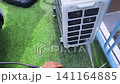 Air Conditioner Cleaning and Maintenance Service Technician Repairing Indoor AC Unit 141164885