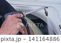 Air Conditioner Cleaning and Maintenance Service Technician Repairing Indoor AC Unit 141164886