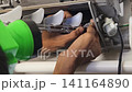 Air Conditioner Cleaning and Maintenance Service Technician Repairing Indoor AC Unit 141164890