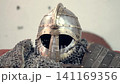 A highly detailed view of medieval ornaments. Featuring antique style, knives, a helmet, Norse symbols, accessories, irons, and a scabbard. Medieval knight's clothing and accessories. 141169356