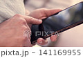 Beautiful mature Latina executive professional, with headphones and her cell phone, working on her laptop and enjoying the day, sitting in a park. Learning, home office 141169955