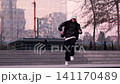 Young Latino man breakdancing downtown, surrounded by buildings. Lots of attitude and urban style. Urban youth dances with lots of attitude. 141170489