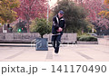 Young Latino man breakdancing downtown, surrounded by buildings. Lots of attitude and urban style. Urban youth dances with lots of attitude. 141170490