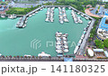 Drone footage from above showing a group of yachts anchored on a calm body of water. Drone footage from above showing a group of yachts anchored on a calm body of water. 141180325