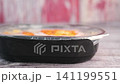 Preparing a homemade meal in a black baking dish 141199551