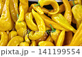 Yellow peppers displayed at local market stand 141199554