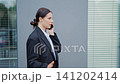 Professional Businesswoman Having a Serious Phone Conversation Outdoors 141202414