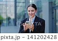 Smiling Business Professional Interacting with Smartphone 141202428