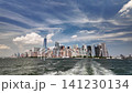 Boat sailing away from lower manhattan skyline view 141230134
