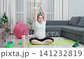 Pregnant woman, stretching and exercise on floor in home for pelvic strength, maternity fitness and improve flexibility. Girl, living room and prenatal yoga for circulation, back pain and posture 141232819