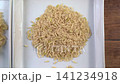 Cinematic dolly video shot showcasing steamed cooked brown jasmine rice next to raw uncooked brown rice grains presented on clean white ceramic square plates for healthy food comparison concept 141234918