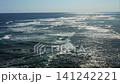 Waves crash against the shallow coral reef. 141242221