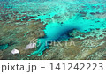 Waves crashing against the crystal-clear emerald green sea 141242223