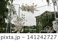 Elegant floral wedding ceremony arch with cascading crystals and greenery 141242727