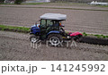 Using a blue tractor to reinforce the levees. 141245992