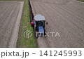 Using a blue tractor to reinforce the levees. 141245993