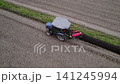 Using a blue tractor to reinforce the levees. 141245994
