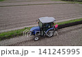 Using a blue tractor to reinforce the levees. 141245995