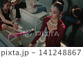Young Gymnast in Sparkling Magenta Performance Leotard Practices Elegant Poi Spinning Routine 141248867