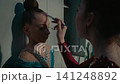 Teenage Gymnast Helping Her Friend Applying Stage Makeup Backstage 141248892